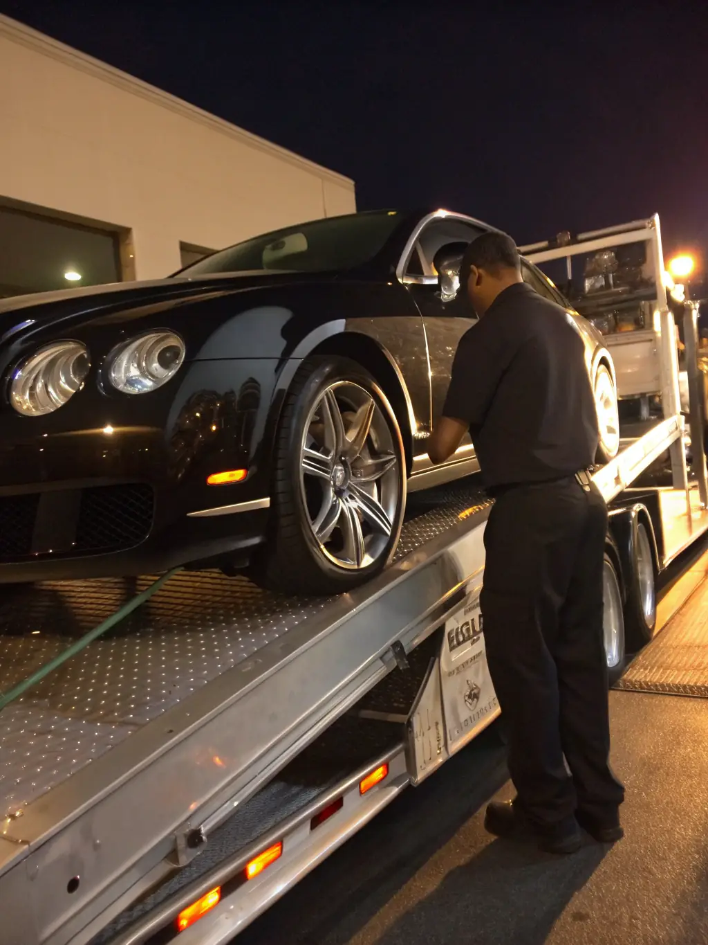 A high-quality photograph showcasing a luxury car being loaded onto a specialized transport carrier for international shipping, emphasizing the care and security involved in the process.
